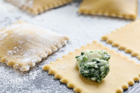 Making ravioli with cottage cheese and spinach at wooden table, closeupの写真素材