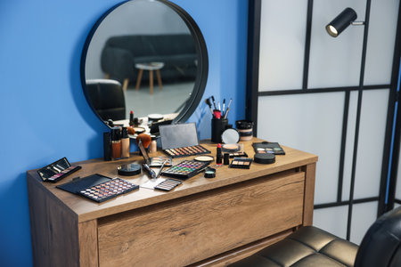 Different makeup products and brushes on vanity indoorsの写真素材