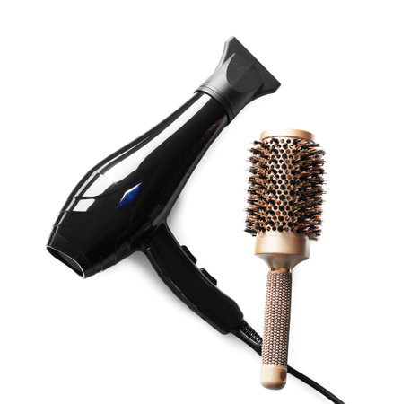Hair dryer and brush isolated on white, top view. Hairdresser's tools