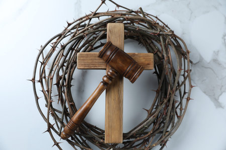 Judge's gavel, wooden cross and crown of thorns on white marble table, top viewの写真素材