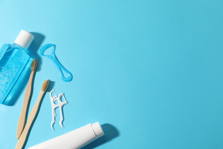 Different oral care products on light blue background, flat lay. Space for textの写真素材