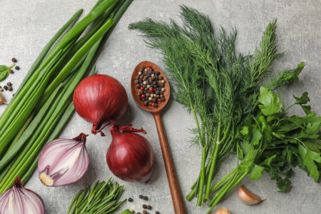 Different herbs and spices on grey table, flat layの写真素材