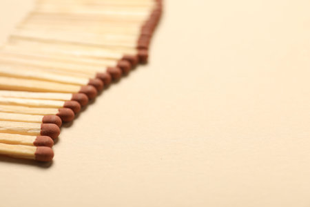 Matches with brown heads on beige background, closeup. Space for textの写真素材