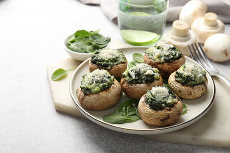 Tasty stuffed mushrooms served on light table, closeupの写真素材