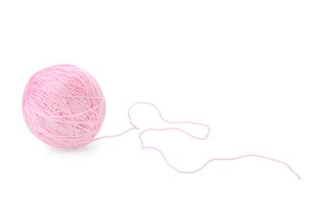 Ball of pink yarn isolated on whiteの写真素材