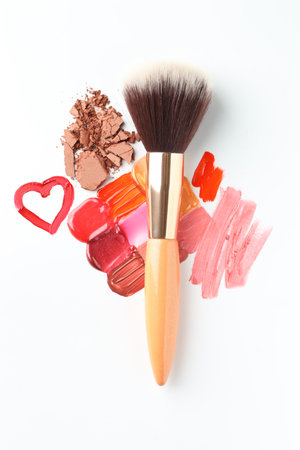 Different cosmetic products and makeup brush on white background, flat layの写真素材