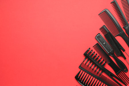 Different hairdresser's tools on red background, flat lay. Space for textの写真素材