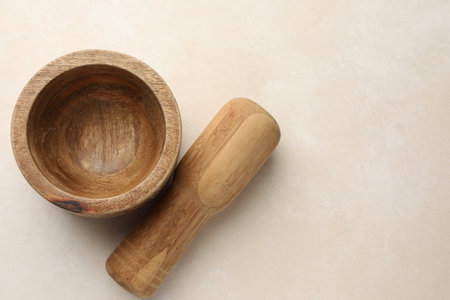 Wooden mortar and pestle on white table, top view. Space for textの写真素材