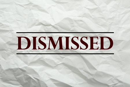 Word Dismissed on crumpled paper as backgroundの写真素材