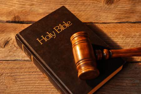Judge's gavel and Bible on wooden table, above viewの写真素材