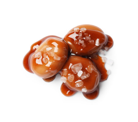 Tasty sweet candies, salt and caramel sauce isolated on white, top viewの写真素材