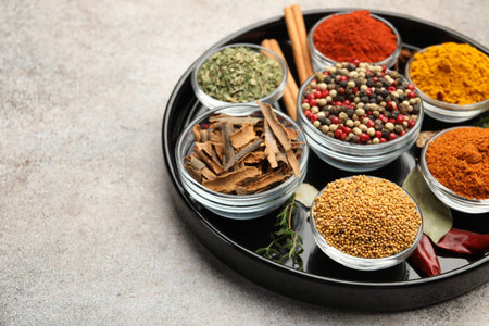 Different aromatic spices on light grey table, closeup. Space for textの写真素材