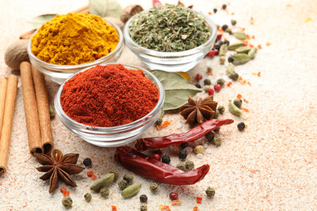 Different aromatic spices on color textured table, closeup. Space for textの写真素材
