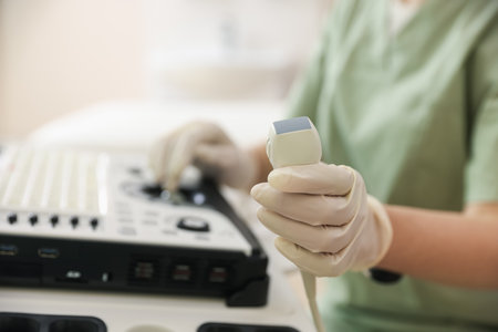 Professional sonographer with ultrasound machine in clinic, closeupの写真素材