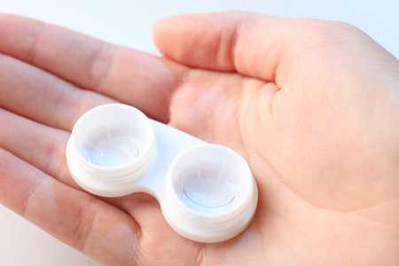 Woman with contact lenses on light background, closeupの写真素材