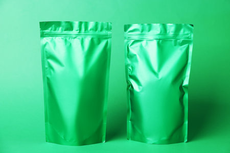 Zipper stand-up pouches on green background. Mockup for designの写真素材