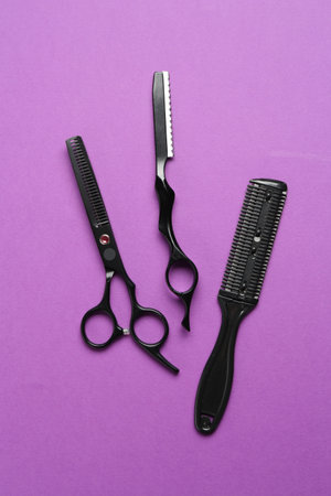 Different hairdresser's tools on violet background, flat layの写真素材