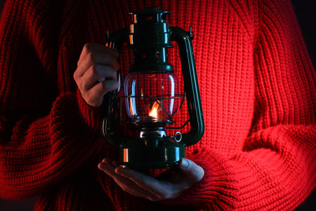 Woman holding vintage kerosene lantern, closeup viewの写真素材