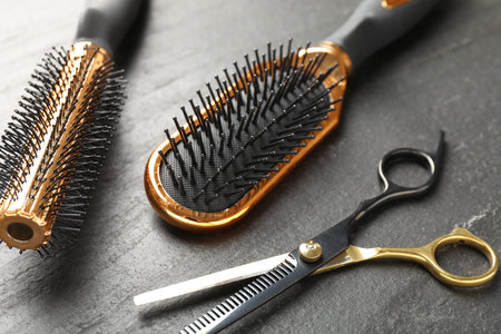 Different barber's tools on black table, closeup