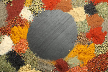 Different aromatic spices on dark textured table, top view. Space for textの写真素材
