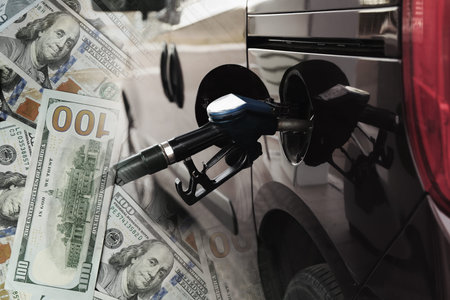 Fuel price. Refueling car at gas filling station and dollar banknotes, double exposureの写真素材