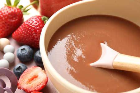 Baby food. Tasty puree in bowl and ingredients on table, closeupの写真素材
