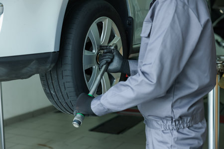 Mechanic changing tire at car service, closeupの写真素材