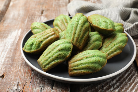 Tasty matcha madeleine cakes on wooden table, closeupの写真素材