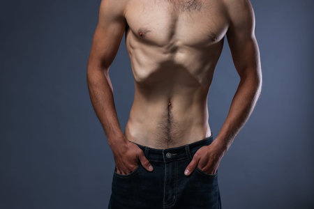 Man suffering from anorexia on grey background, closeup