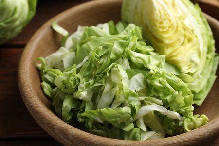 Cut fresh cabbage in bowl on table, closeupの写真素材