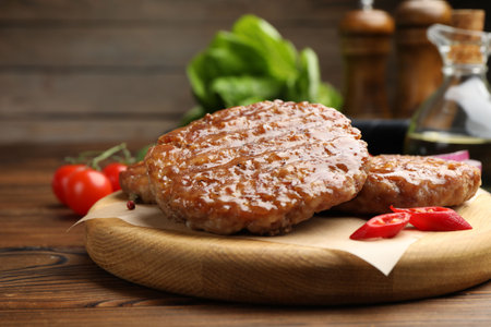 Delicious hamburger patties and spices on wooden table, closeupの写真素材