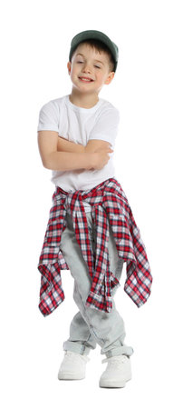 Happy little boy in baseball hat dancing on white backgroundの写真素材