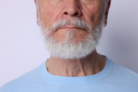 Man with silver beard on light background, closeupの写真素材