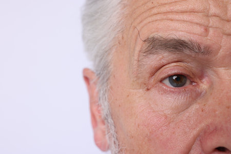 Confident senior man on light background, closeupの写真素材