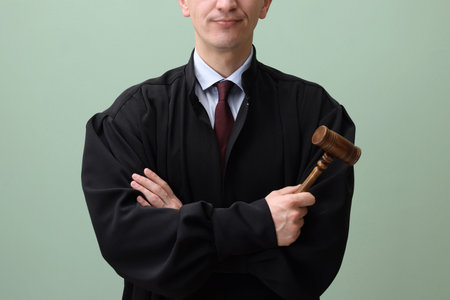 Judge with mallet on green background, closeupの写真素材