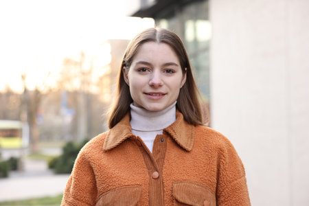 Portrait of beautiful teenage girl on city street