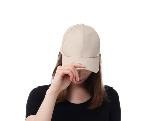 Young woman wearing stylish beige baseball hat on white backgroundの写真素材