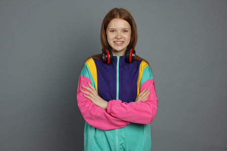 Portrait of teenage girl on grey background
