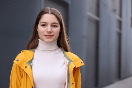 Portrait of beautiful teenage girl on blurred background, space for text