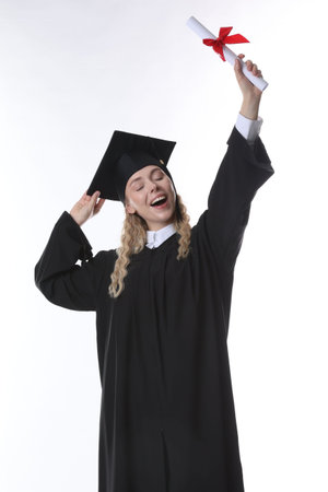 Happy student with diploma after graduation on white backgroundの写真素材