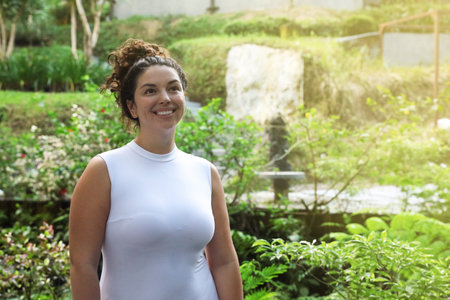 Portrait of happy woman in tropical park, space for text