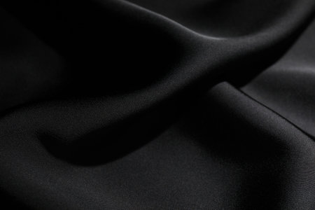 Crumpled black silk fabric as background, closeup