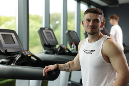 Personal trainer wearing clothing with description in gym