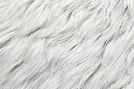 Texture of white furry fabric as background, closeup
