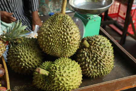 Fresh ripe durians on counter at market, closeup