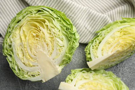 Pieces of fresh cabbage on grey table, flat layの写真素材