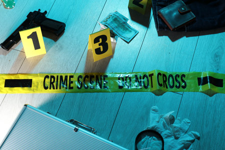 Forensic expertise. Crime scene with evidence, markers and police tape on floor. Color toned effectの写真素材