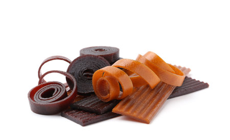 Different delicious fruit leather on white background