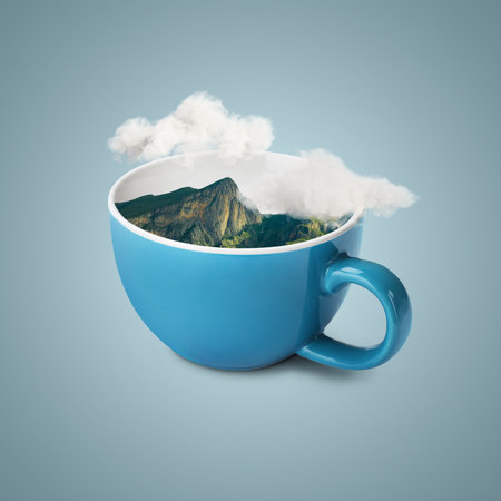 Clouds above mountains in cup against light greyish blue backgroundの写真素材