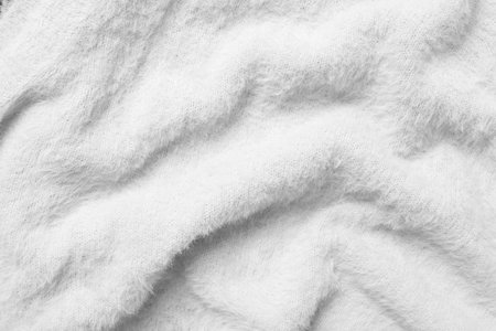 Texture of white fluffy fabric as background, top viewの写真素材